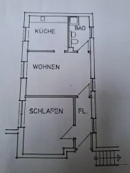 Ein Grundriss einer Wohnung mit den Räumen Küche, Bad, Wohnen und Schlafen. Die Anordnung der Räume ist klar und einfach strukturiert.